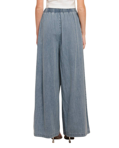 Detalle de pliegues en pantalón palazzo de mezclilla ligera