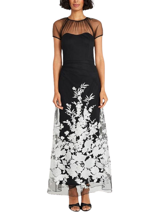 Vestido largo negro con transparencias de tul y bordado floral blanco vista frontal.